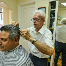 A barber giving a client a haircut.